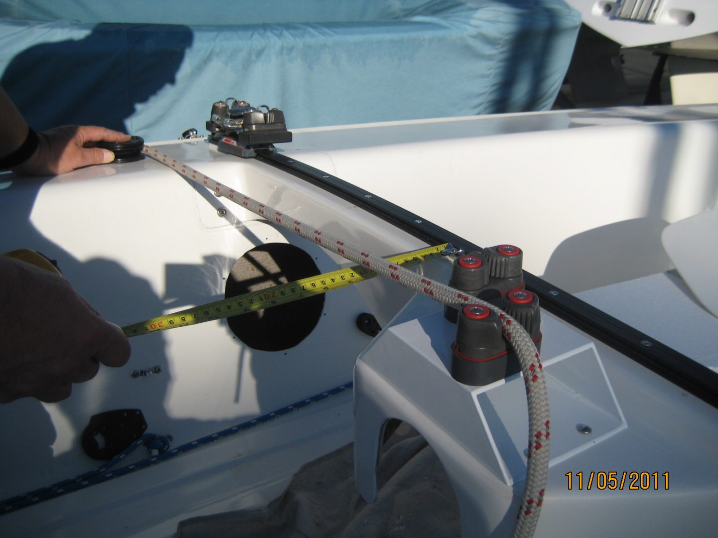 A person is measuring the length of a boat.