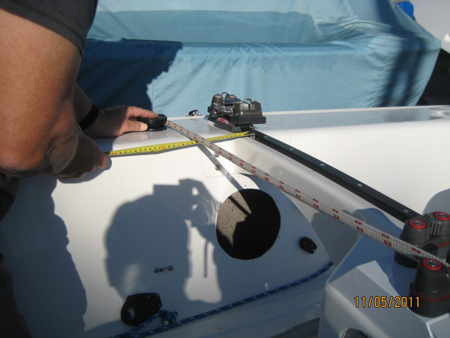 A person is measuring the length of a boat.