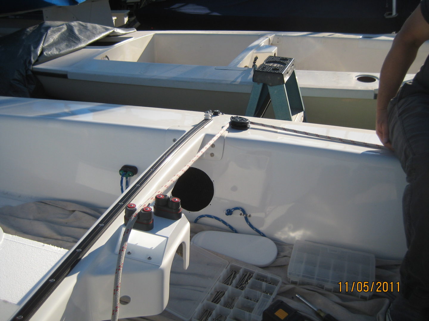 A boat with two large boats on it's deck.