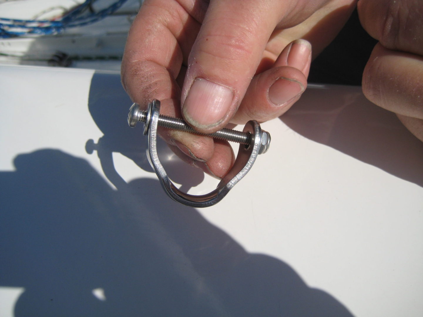 A person holding onto the handle of a metal object.