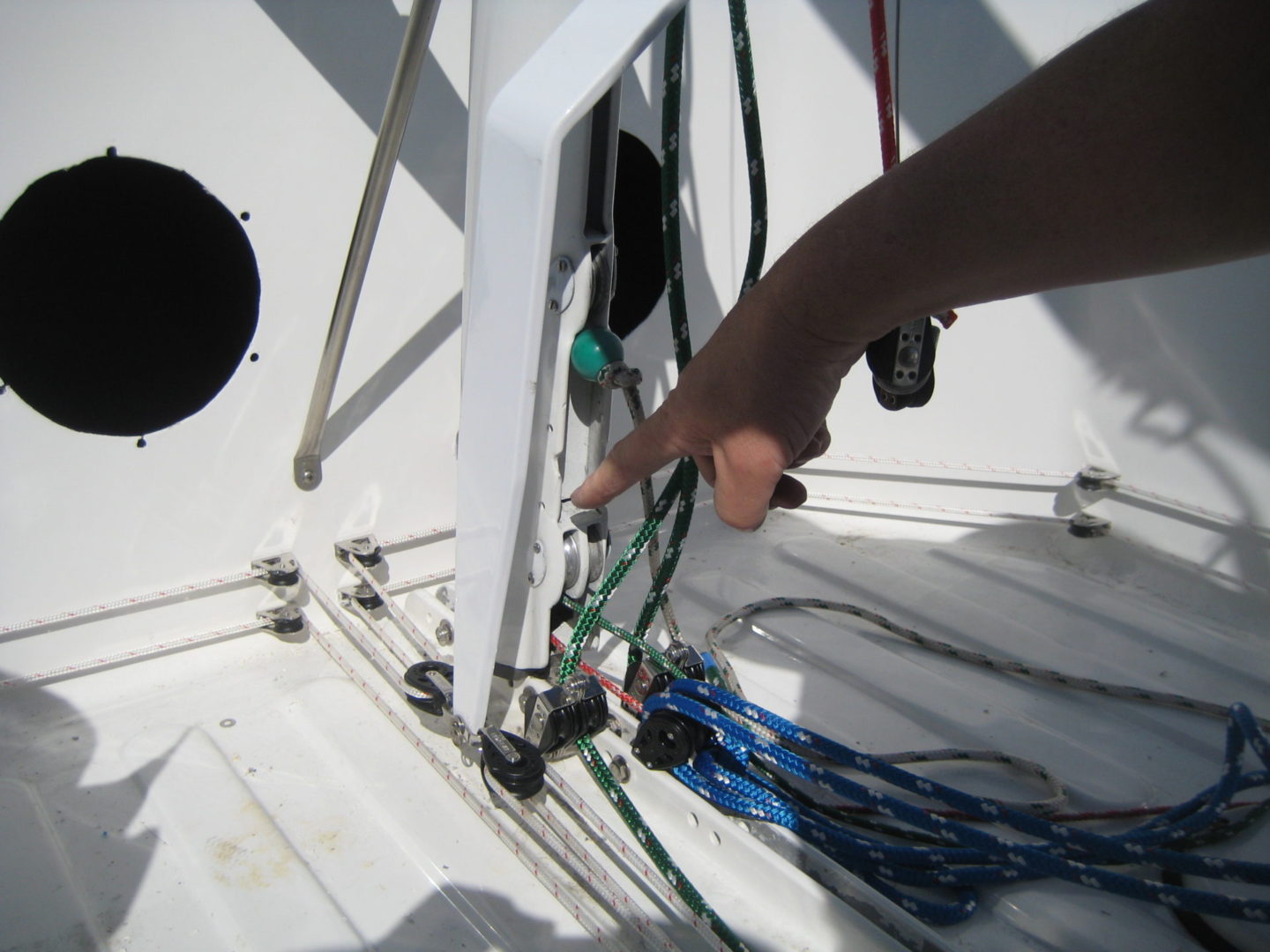 A person working on the wires of a boat.