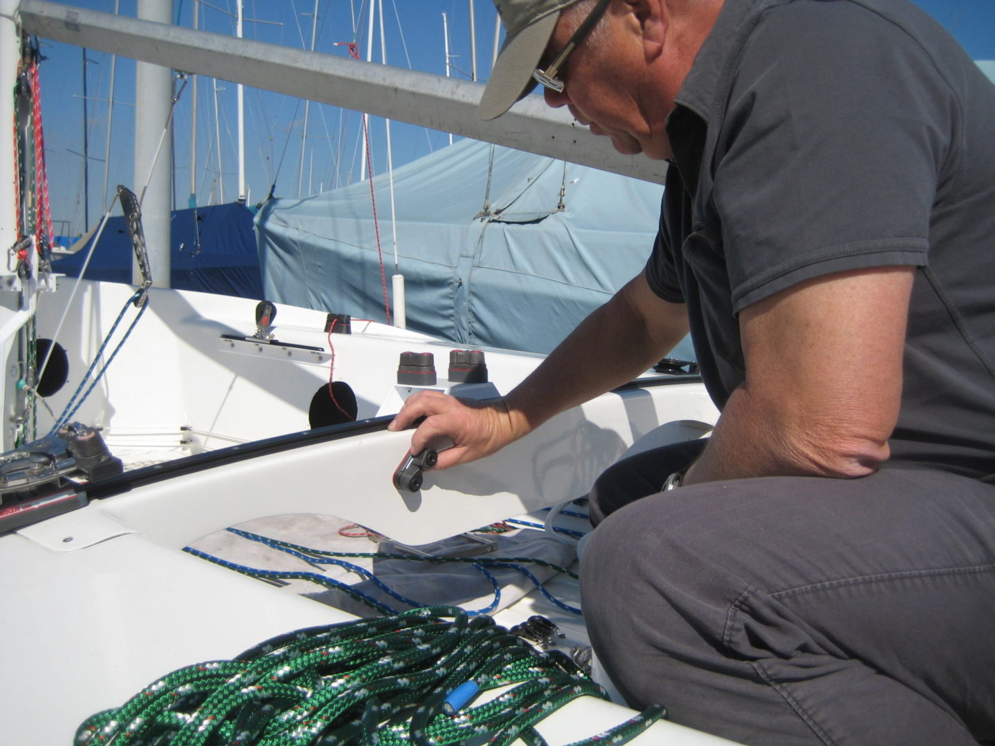 A man sitting on the deck of a boat.