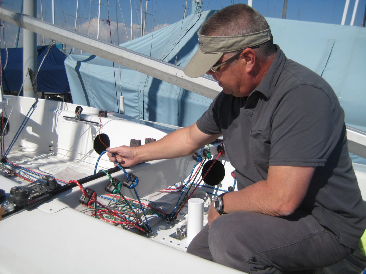 A man working on the electronics of a boat.