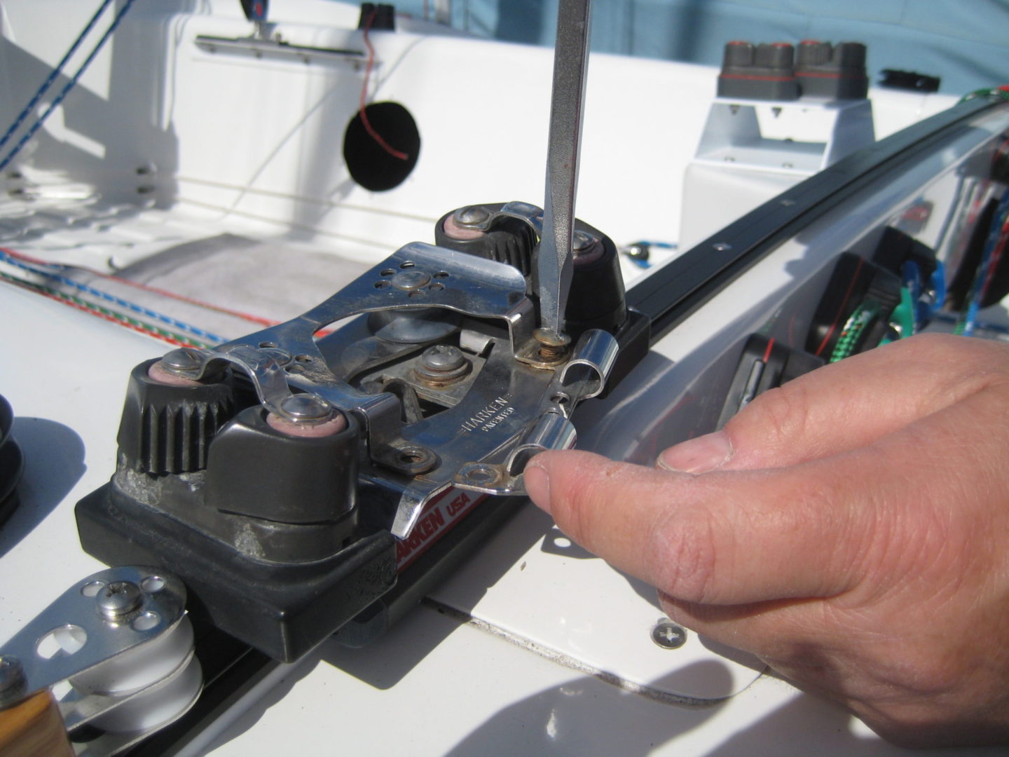 A person using a pair of scissors to cut the wire.